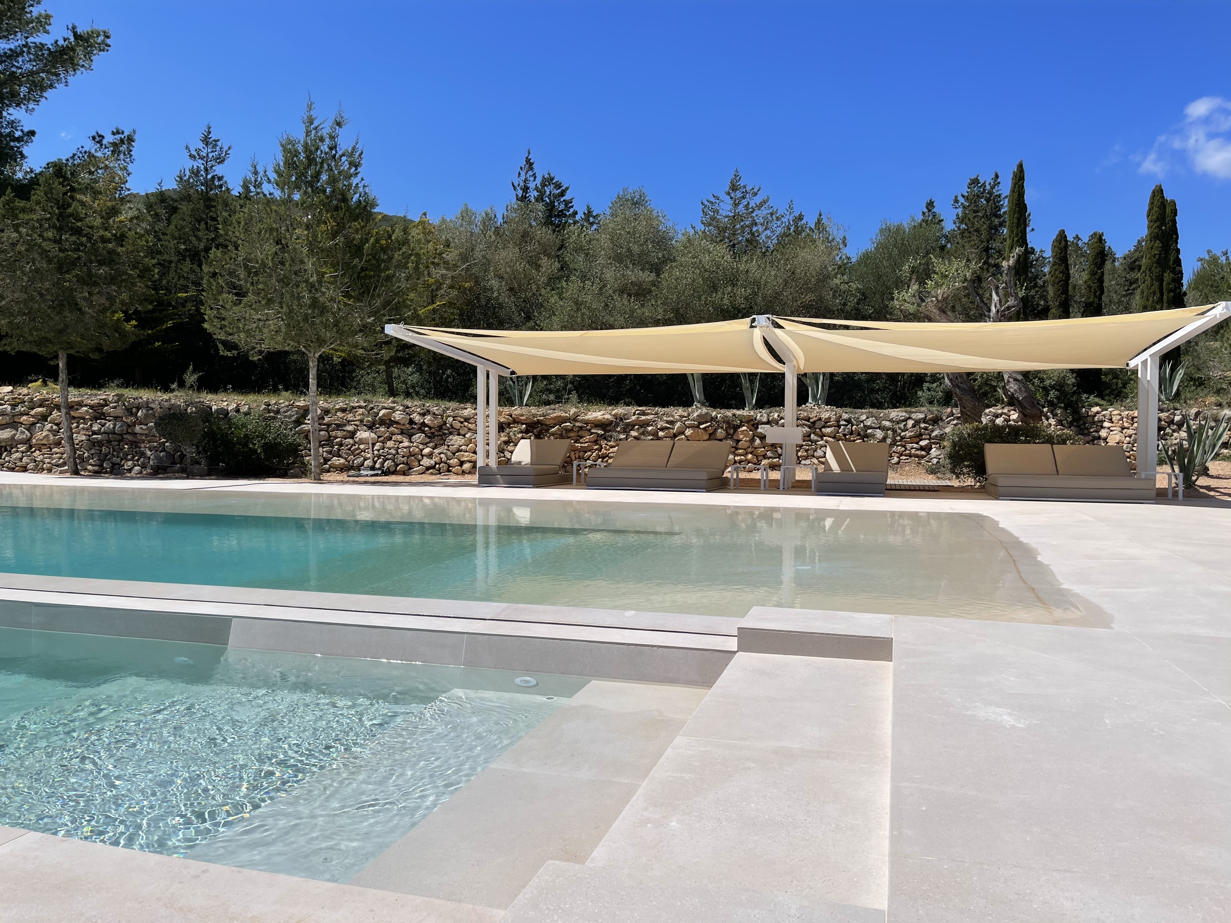 Triangular shade sail at poolside